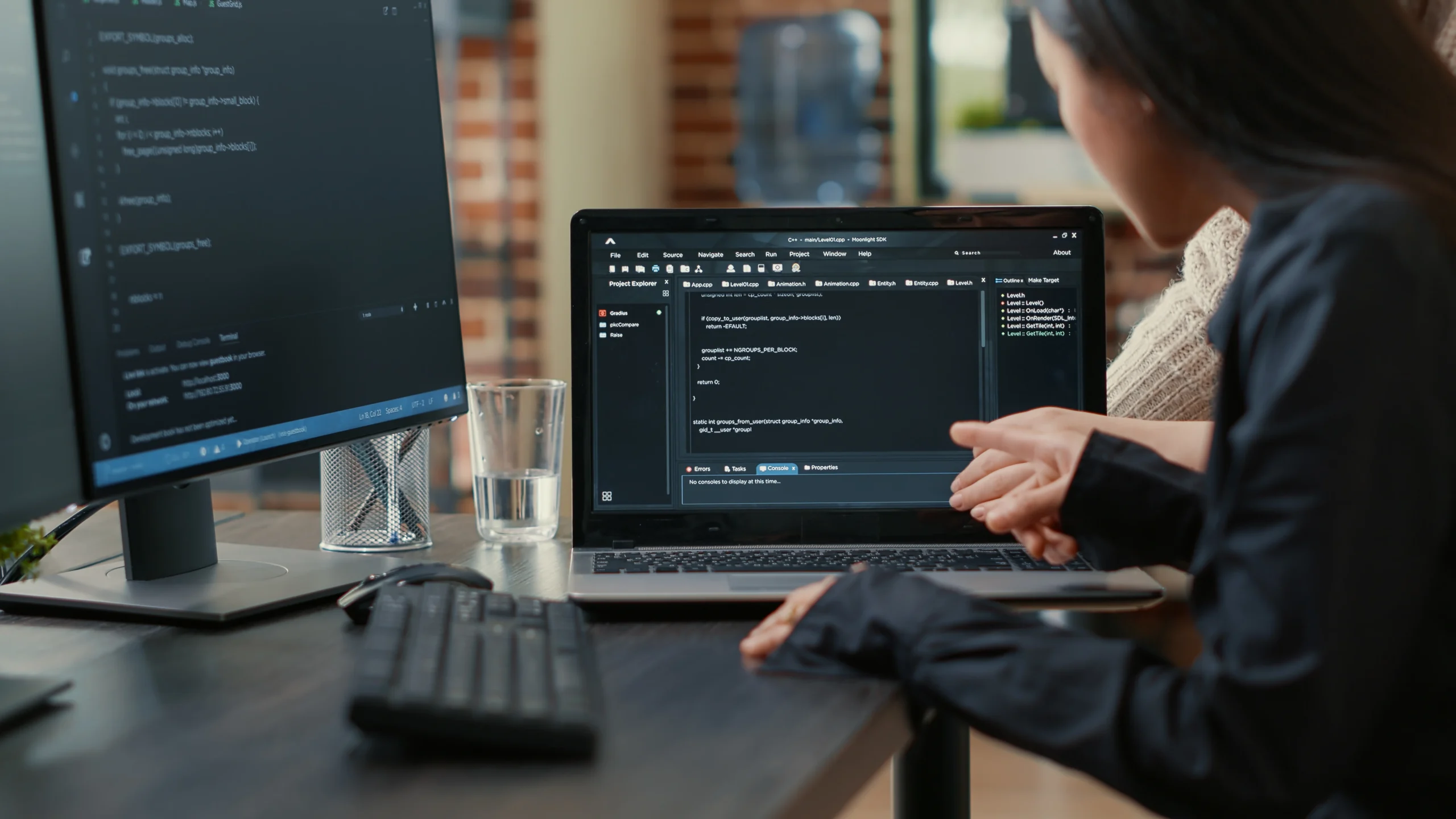 team-programmers-talking-about-algorithm-running-laptop-screen-pointing-source-code-while-sitting-desk-software-developers-collaborating-data-coding-group-project